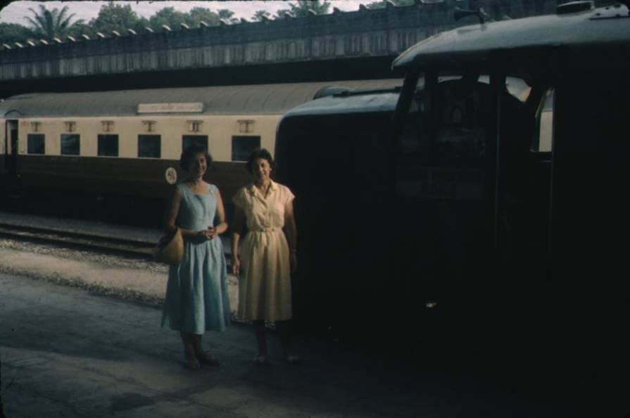 A group of women standing next to a train

Description automatically generated with medium confidence