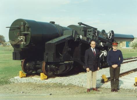 A couple of men standing next to a train

Description automatically generated with low confidence