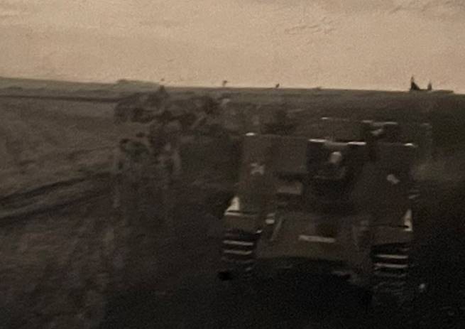 A black and white photo of a military vehicle in a field

Description automatically generated with low confidence