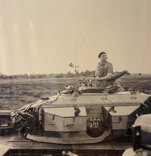 A person sitting on a tank

Description automatically generated with low confidence