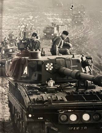 A black and white photo of a tank with men on it

Description automatically generated with low confidence