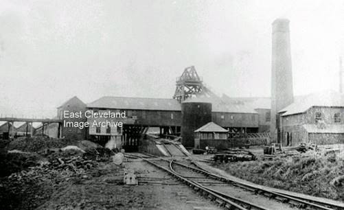 A black and white photo of a factory

Description automatically generated