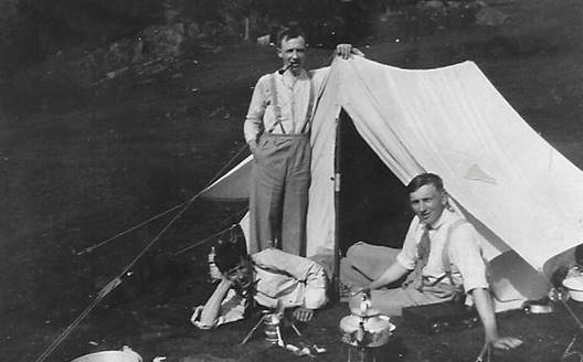 A group of men in front of a tent

Description automatically generated