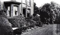 A black and white photo of a house and some trees

Description automatically generated with low confidence