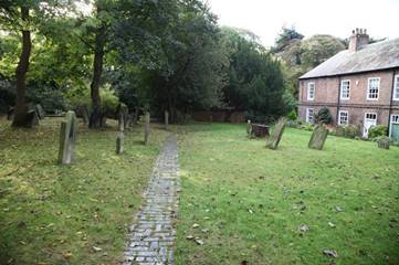 A stone path in a cemetery

Description automatically generated