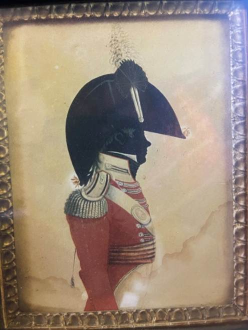 A framed picture of a person in a uniform
AI-generated content may be incorrect.