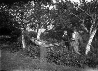 A person and person carrying a hammock
Description automatically generated
