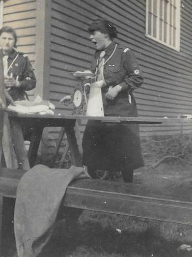 A group of women standing in front of a bench
Description automatically generated