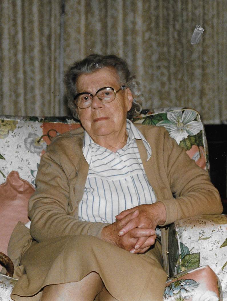 An old person sitting on a couch
Description automatically generated