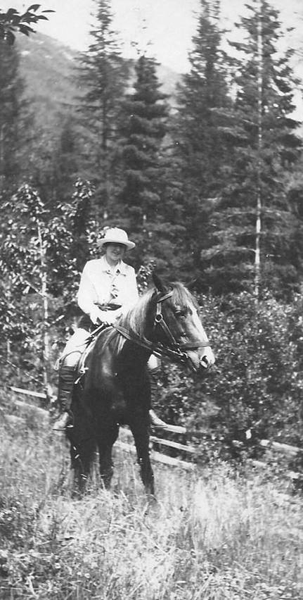A black and white photo of a person in a forest
Description automatically generated