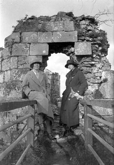 A couple of women posing for a picture
Description automatically generated