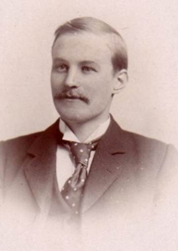 A person in a suit and tie

AI-generated content may be incorrect.