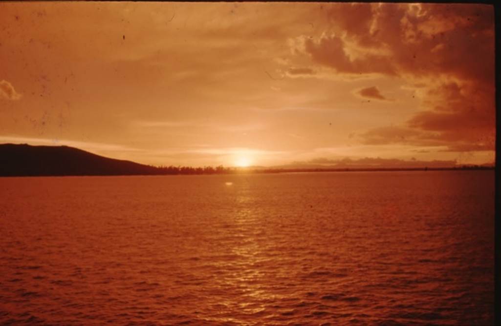 A sunset over a body of water
Description automatically generated with medium confidence