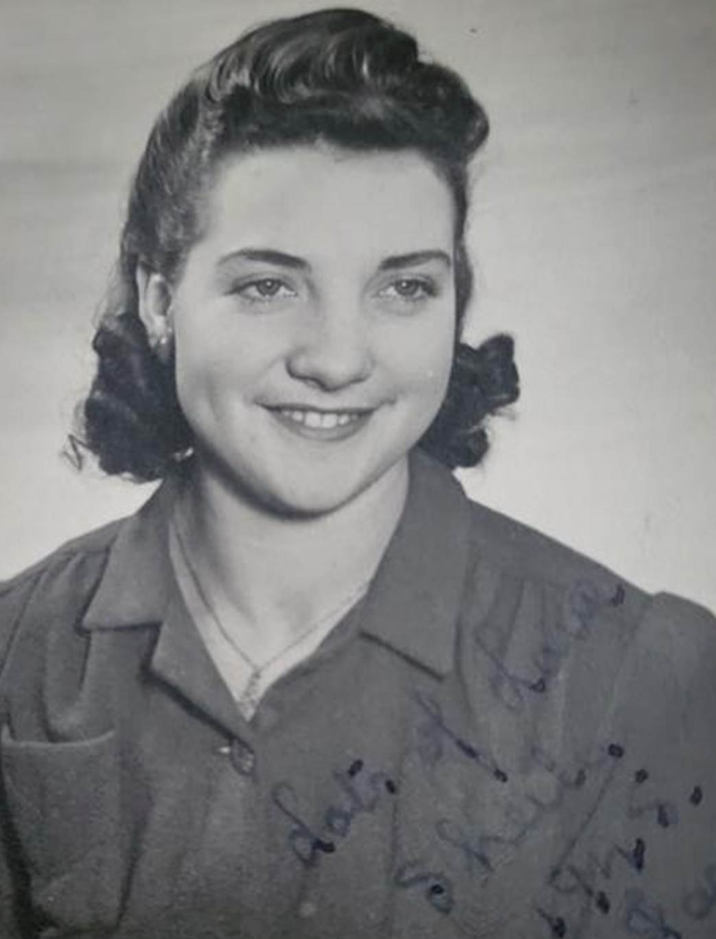 A black and white photo of a person
Description automatically generated