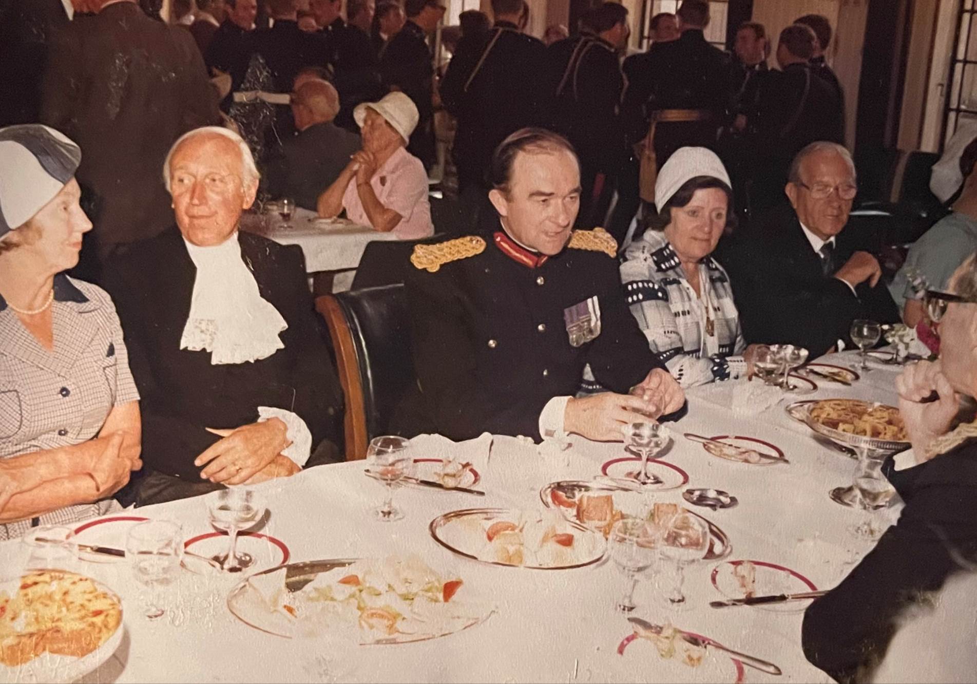 A group of people sitting at a table with food
Description automatically generated with medium confidence
