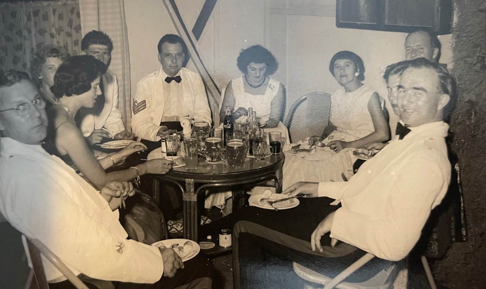 A group of people sitting around a table
Description automatically generated with medium confidence