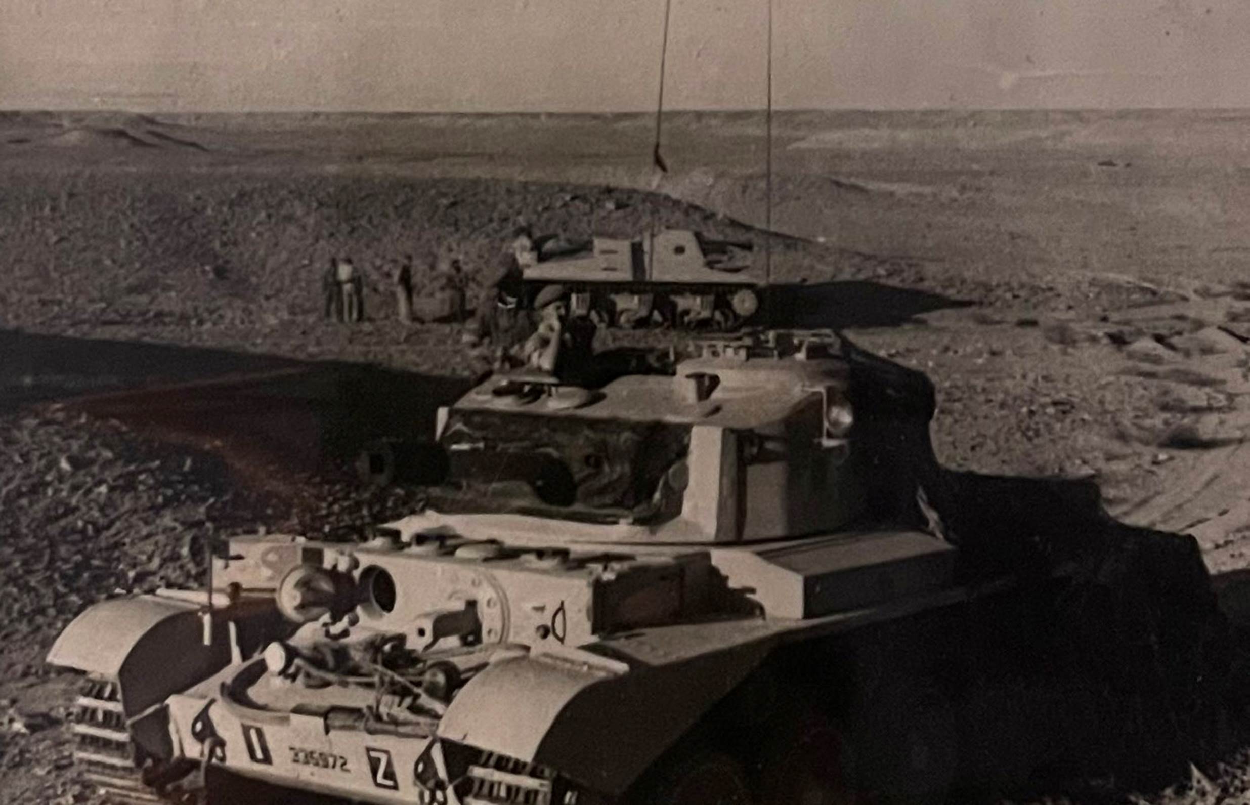 A picture containing text, military vehicle, old, transport
Description automatically generated