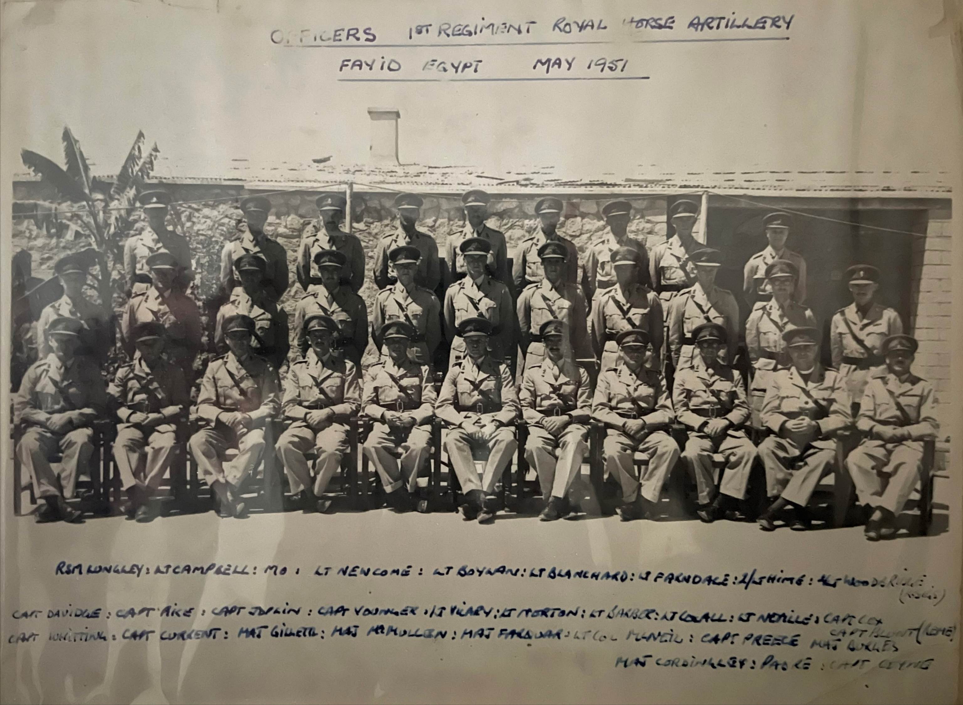 A picture containing text, posing, old, indoor
Description automatically generated
