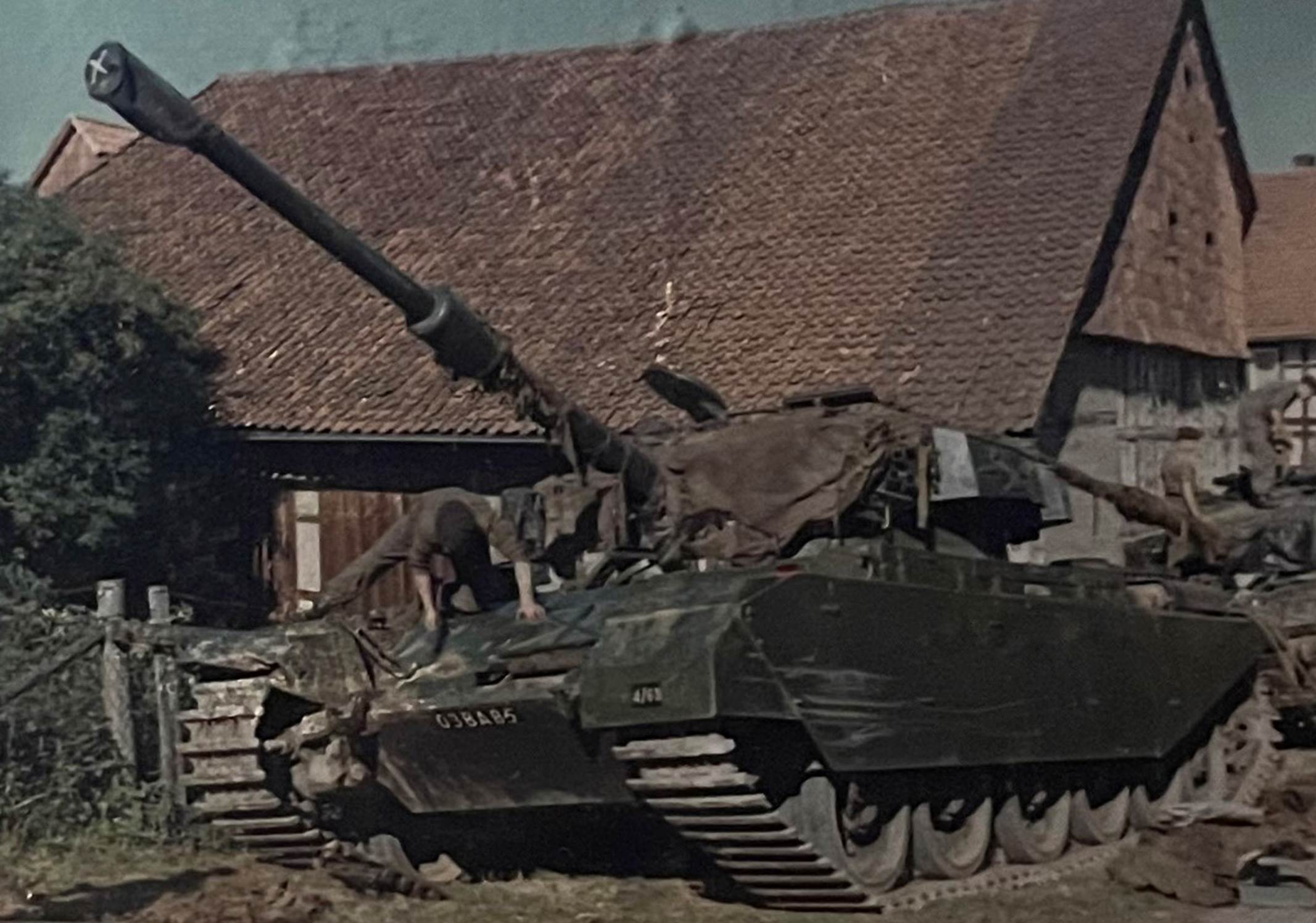 A picture containing military vehicle, transport, old
Description automatically generated