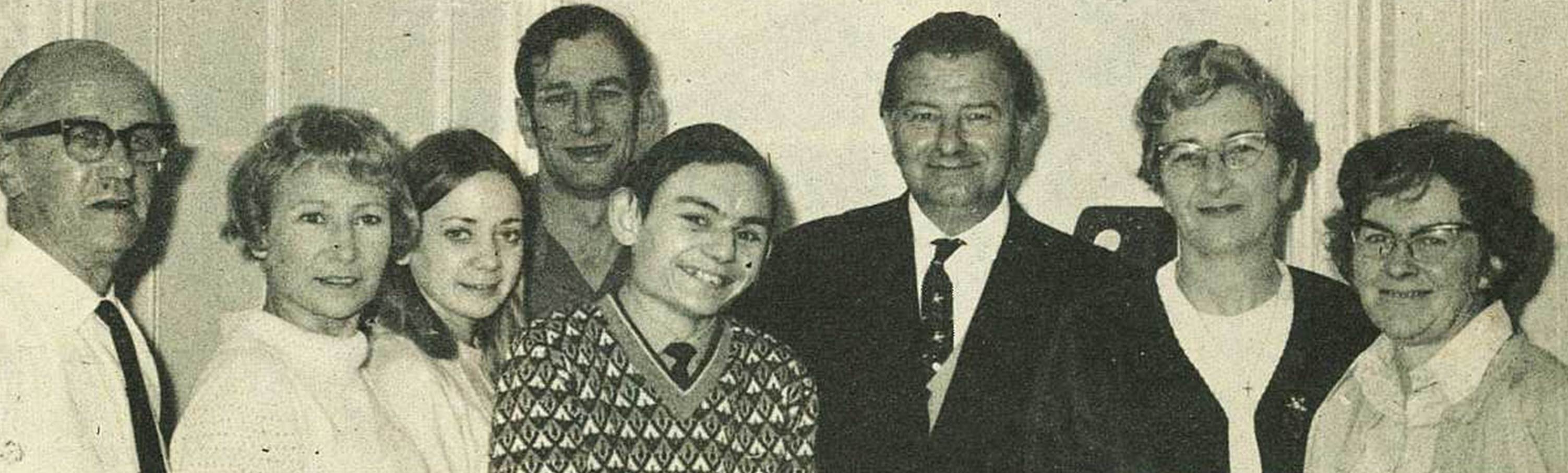 A group of people posing for a photo
Description automatically generated