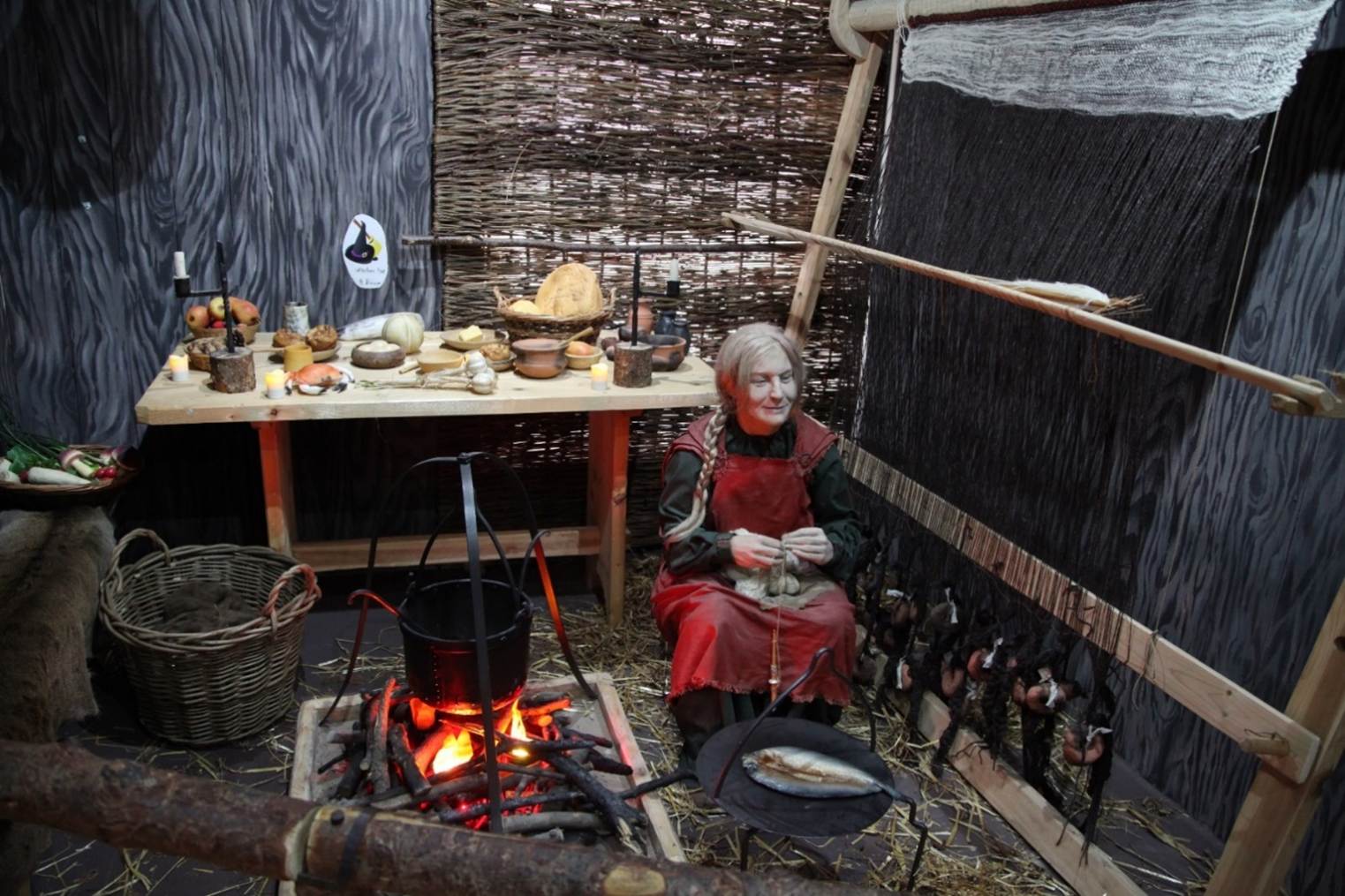 A person sitting in a room with a fire
Description automatically generated