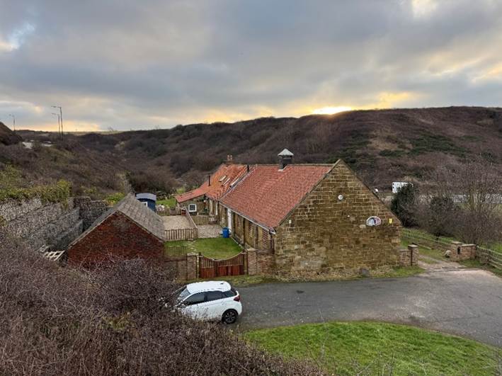A house with a car parked in front of it
AI-generated content may be incorrect.