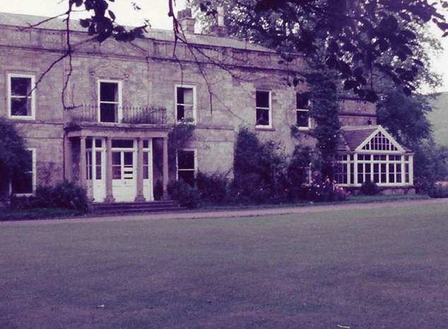 A house with a lawn and a building
Description automatically generated with medium confidence