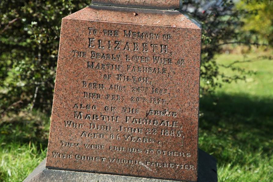 A close-up of a grave stone
Description automatically generated