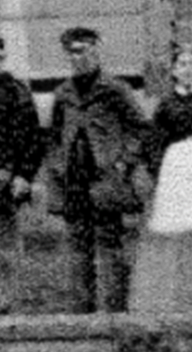A group of people standing outside a brick house
Description automatically generated