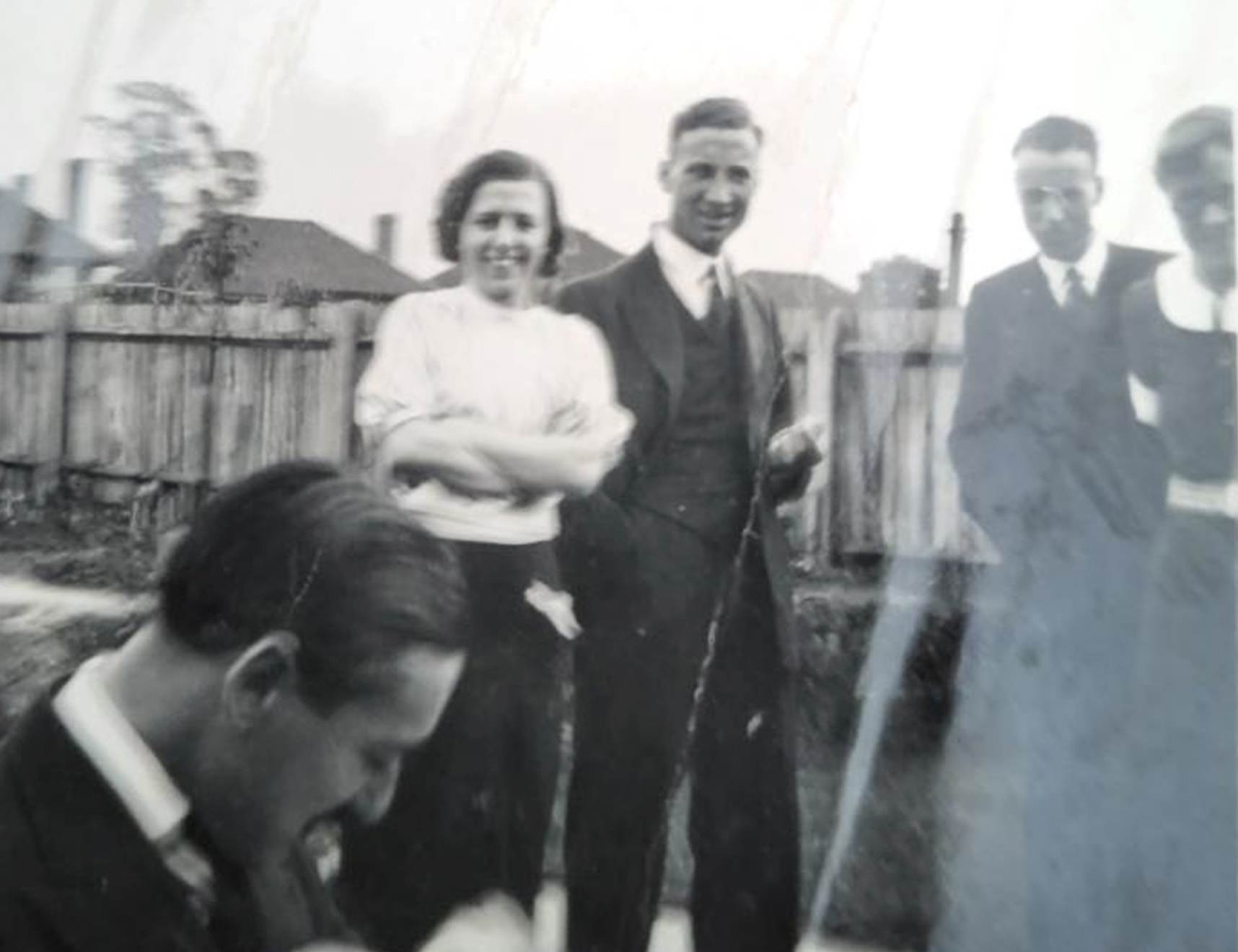 A group of people standing in a yard
Description automatically generated