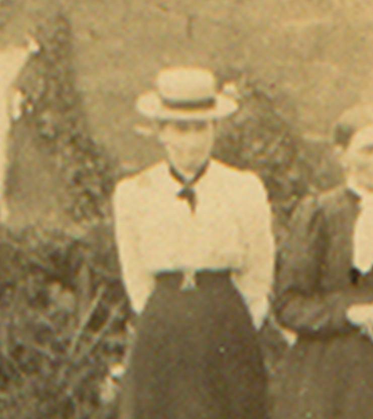A family standing in front of a house
Description automatically generated