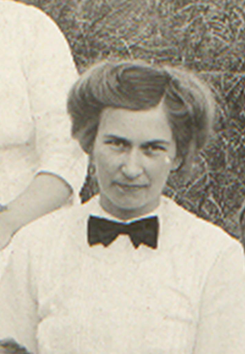 A vintage photo of a group of people posing for the camera
Description automatically generated