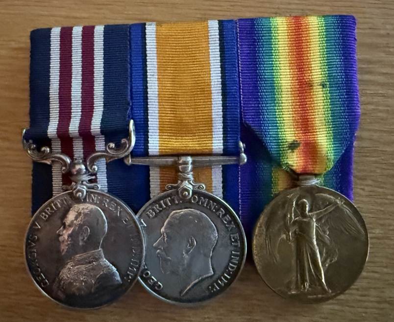 Two medals on a table
Description automatically generated