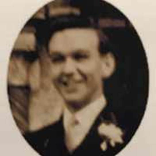 A person in a suit and tie
Description automatically generated