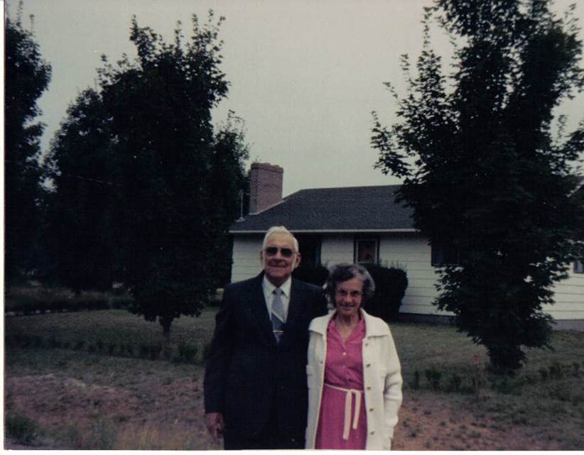 A person and person standing in front of a house
Description automatically generated