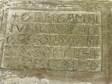 A stone with writing on it

Description automatically generated
