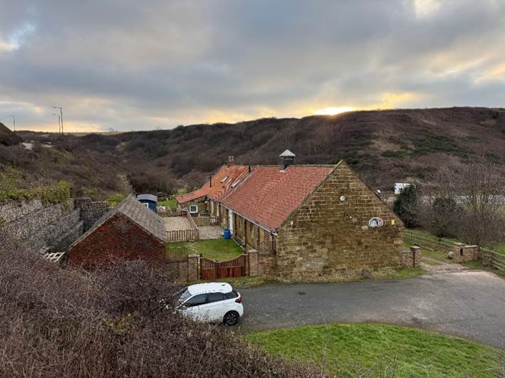 A house with a car parked in front of it

AI-generated content may be incorrect.