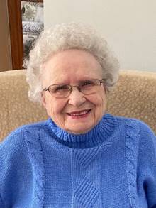 A person wearing a blue sweater
Description automatically generated