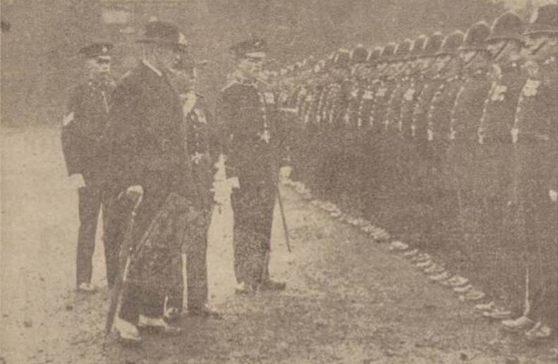 A group of men standing in a line
Description automatically generated