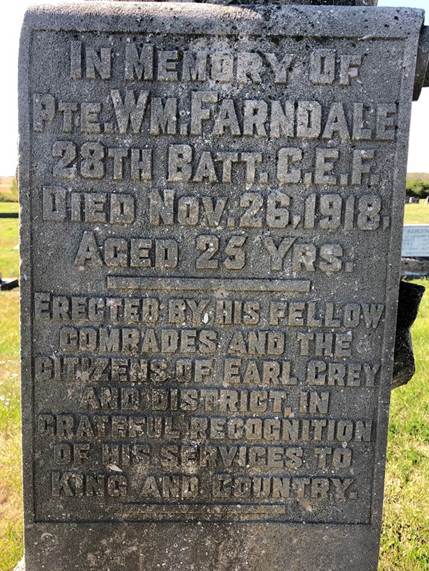A stone monument with text on it
Description automatically generated