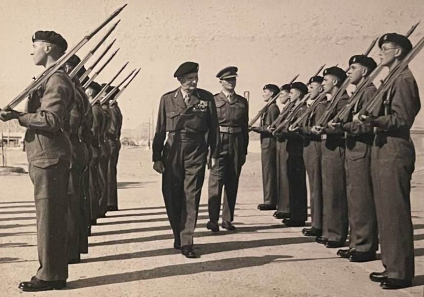 A picture containing text, person, outdoor, military uniform
Description automatically generated