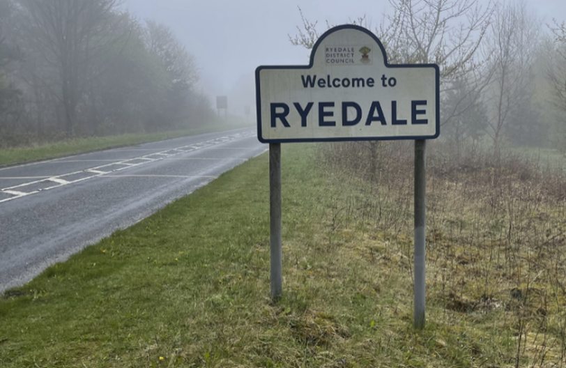A sign on the side of a road
Description automatically generated