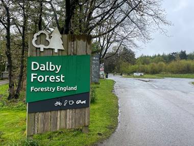 A sign on a wooden board
Description automatically generated