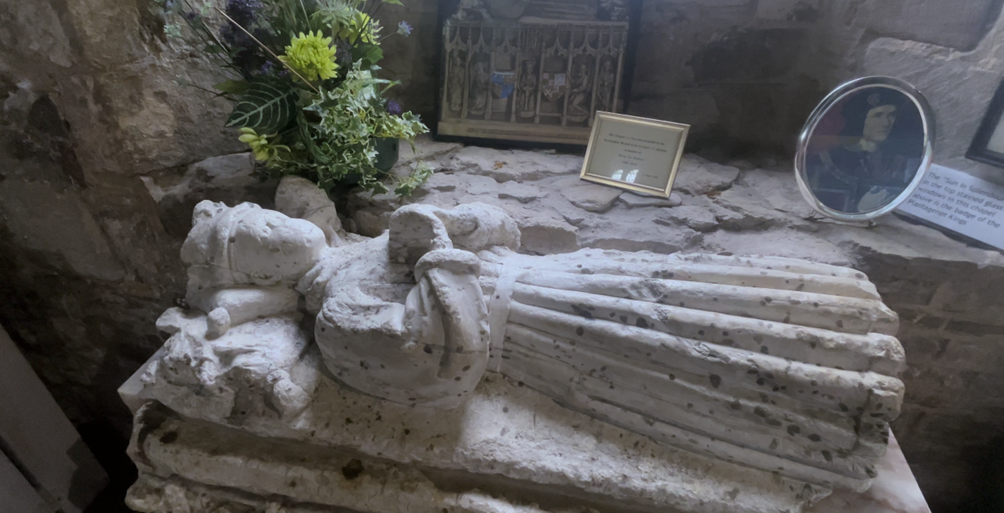 A statue of a person lying on a stone surface
Description automatically generated