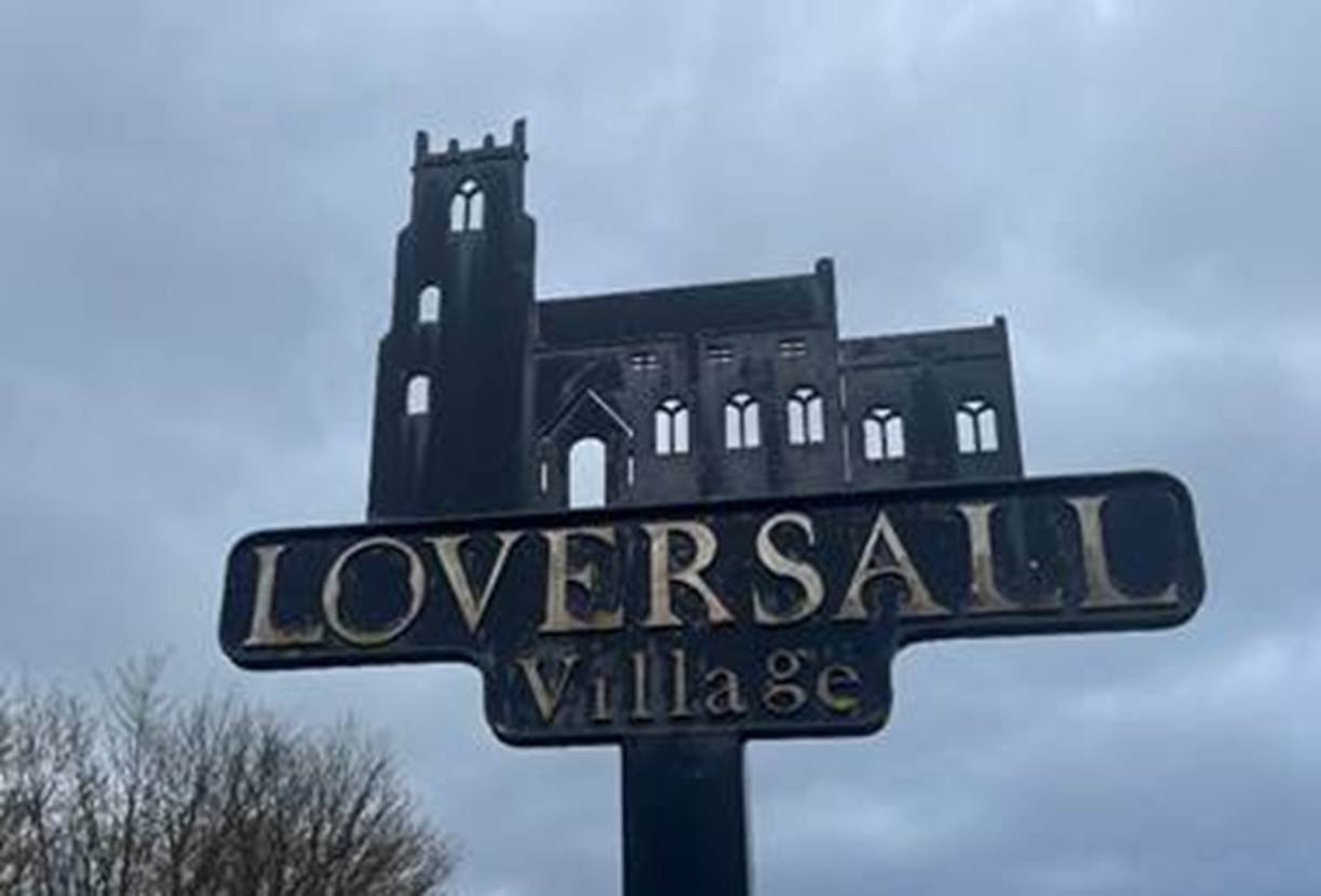 A sign with a castle in the background
Description automatically generated