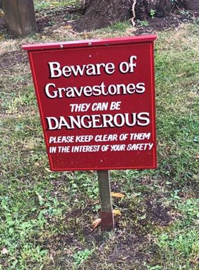 A sign in front of a tree
Description automatically generated