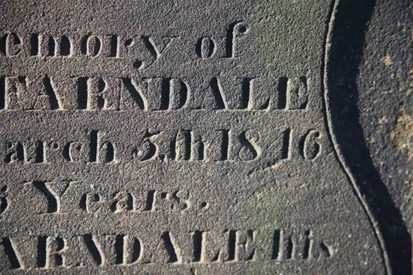 Close-up of a grave stone
Description automatically generated