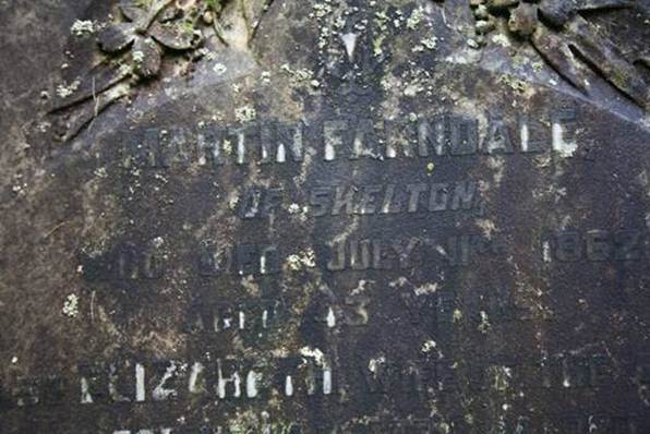 Close-up of a tombstone with engraved text
Description automatically generated