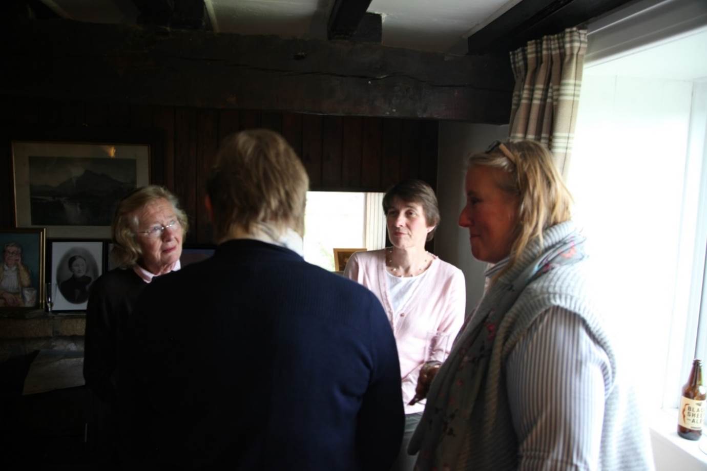 A group of people standing in a room
Description automatically generated