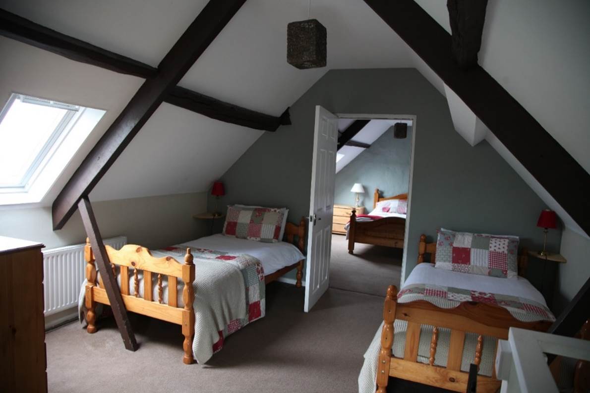 A room with two beds
Description automatically generated